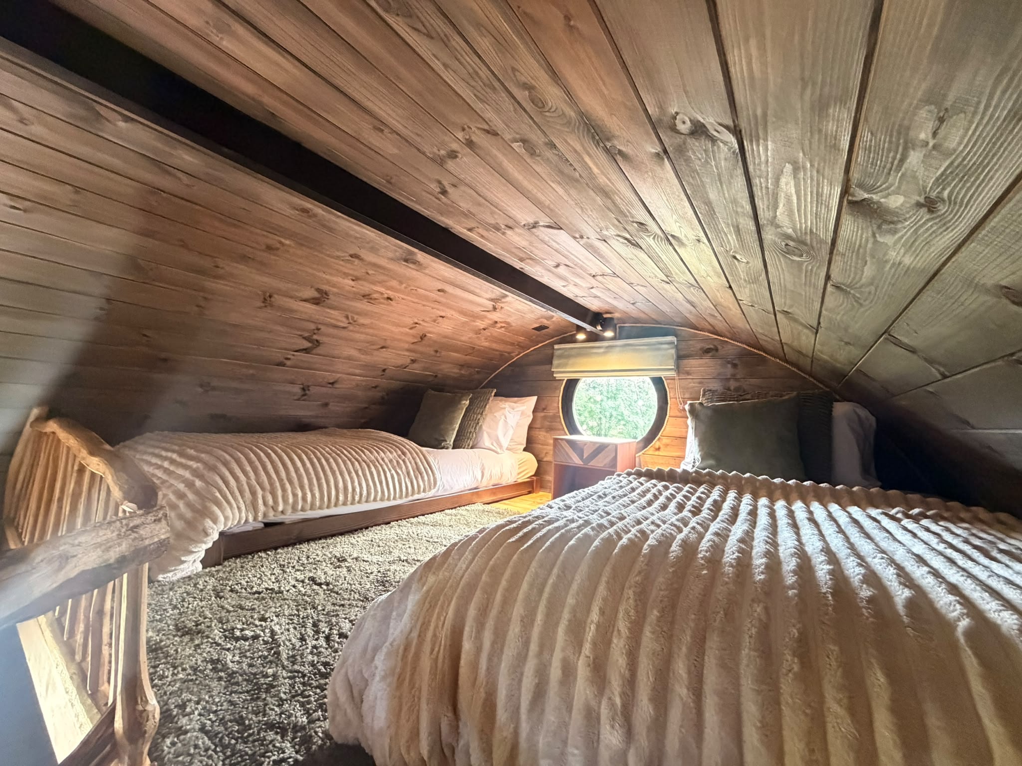Cosy mezzanine sleeping area inside Elmtree Cabins